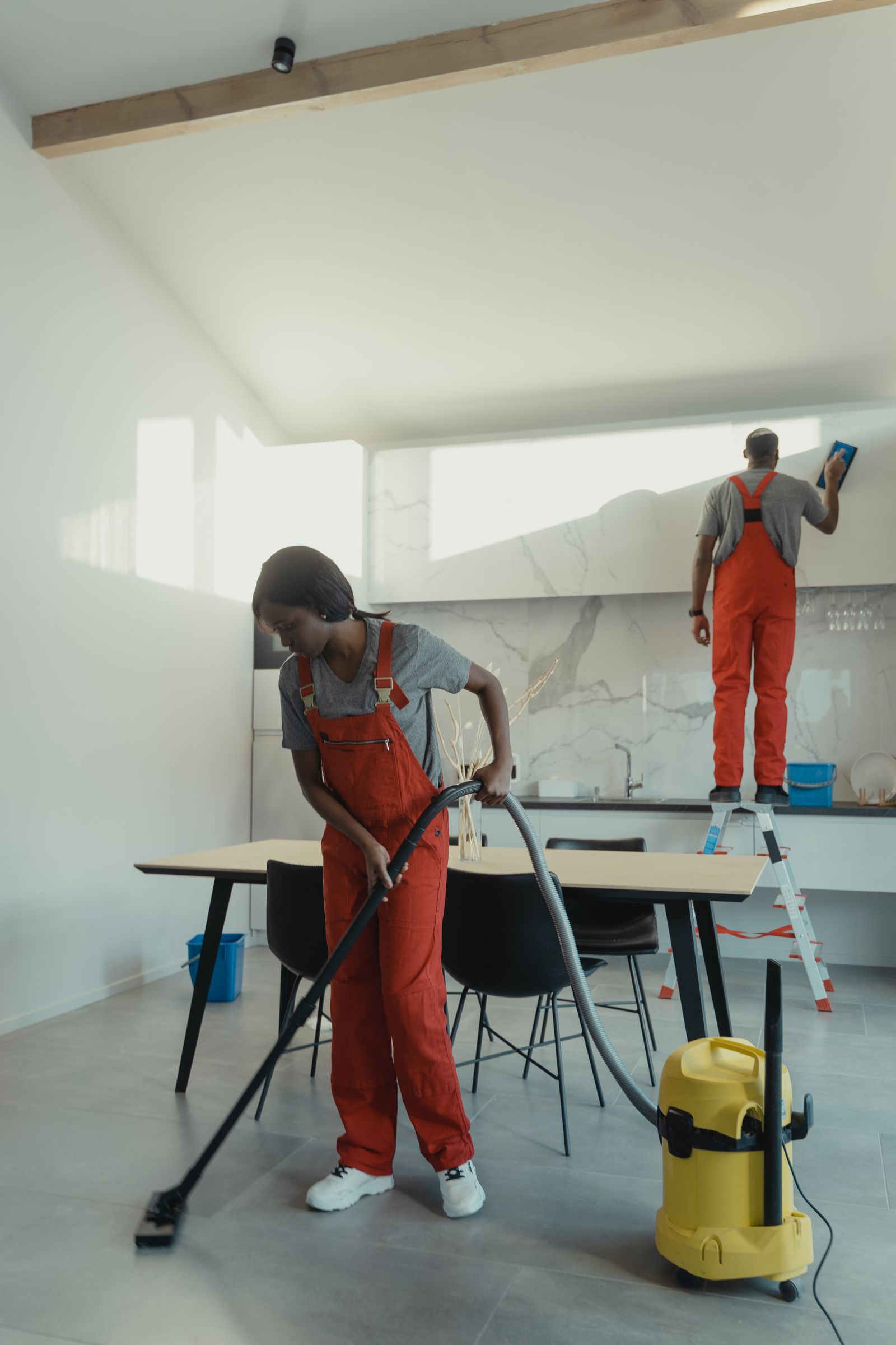 Städpersonal som utför lokalvård med professionell utrustning i en ljus, välskött miljö